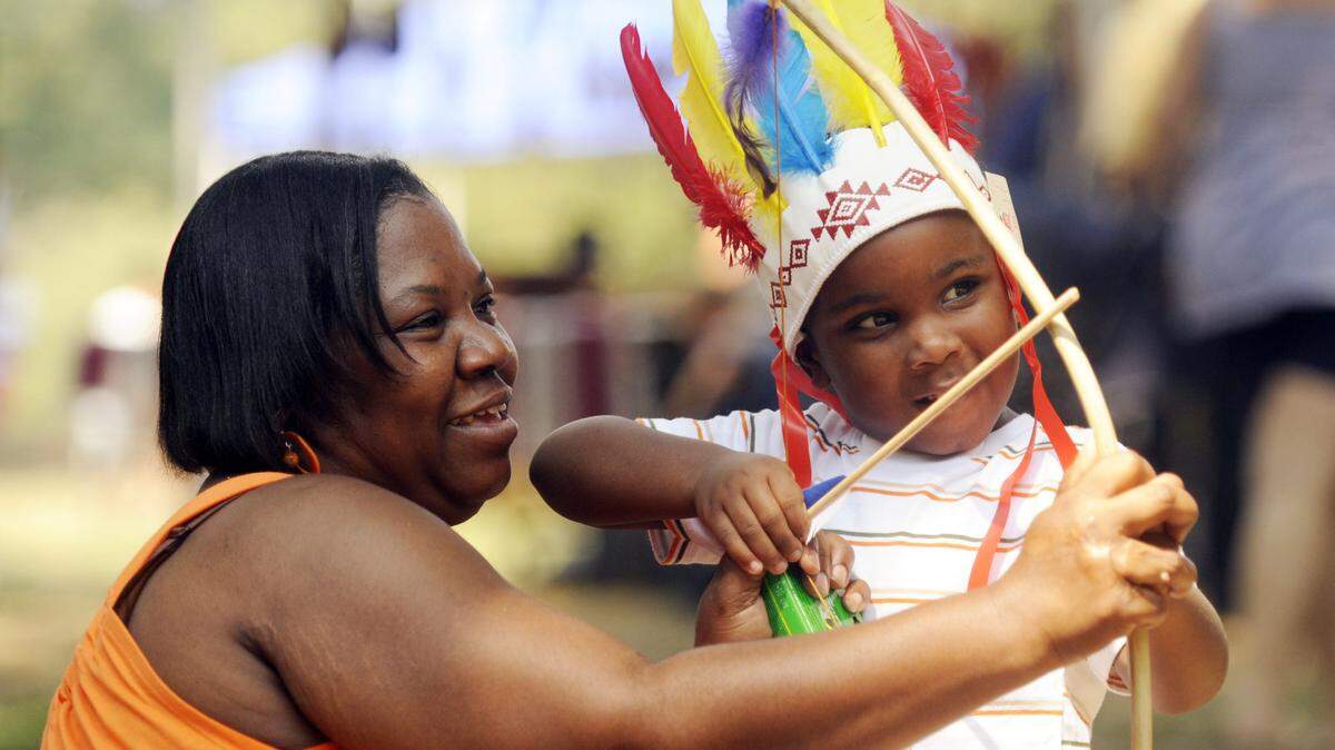 A boy plays with a bow and arrow at the Ocmulgee Indian Celebration in 2010.