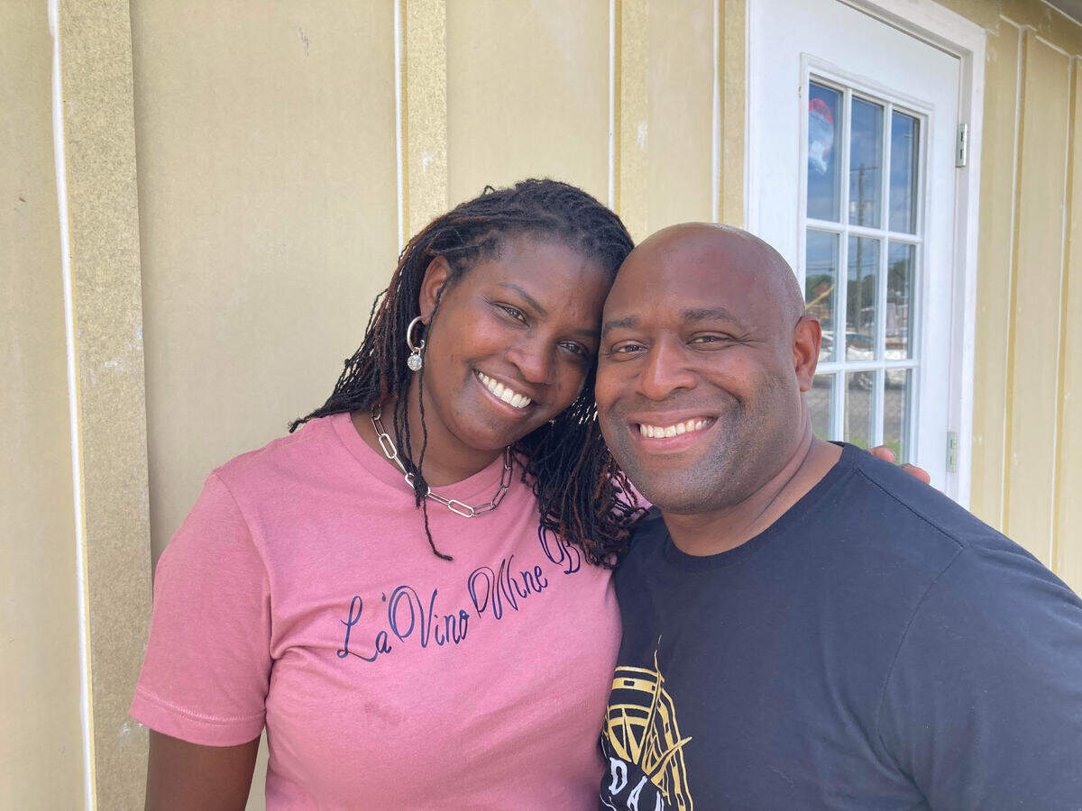 Ebony Lewis, left, with the help of her husband, Marc, is opening La’Vino Wine Bar at 106 South Kimberly Road in Warner Robins. They’re pictured outside on the back patio where she plans to add seating for 20.