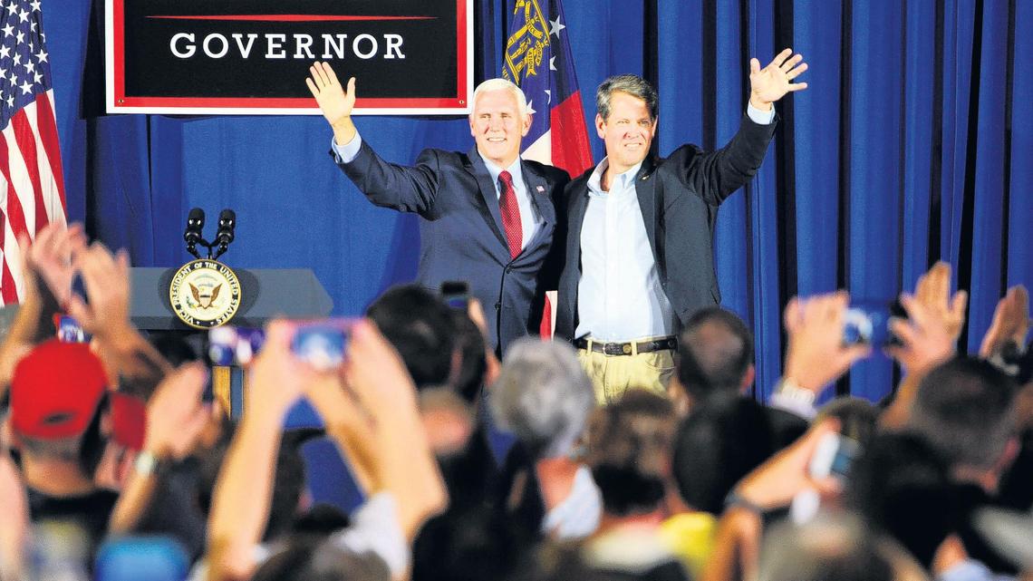 Vice President Mike Pence, left, and gubernatorial candidate Brian Kemp wave to about 1,000 people at a rally in the Wilson Convention Center where Pence gave a ringing endorsement Saturday.