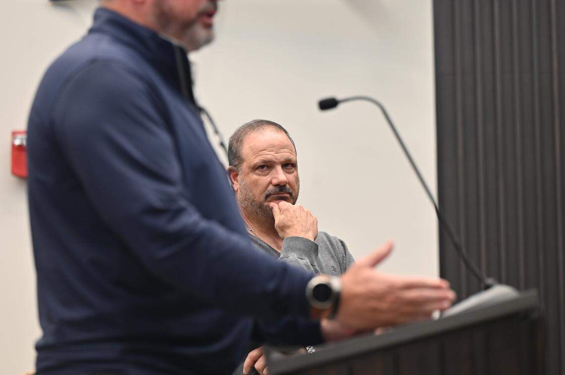 H&H Timberlands co-owner Ty Hanna listens while Trammell Crow Co. executive vice president Drew Fredrick answers questions at the City of Forsyth Planning and Zoning Commission meeting on Wednesday, Jan. 14, 2026, at Forsyth City Hall in Forsyth, Georgia. The commission split the vote 3-3 on approving a conditional rezoning proposal for a proposed data center in Forsyth. 