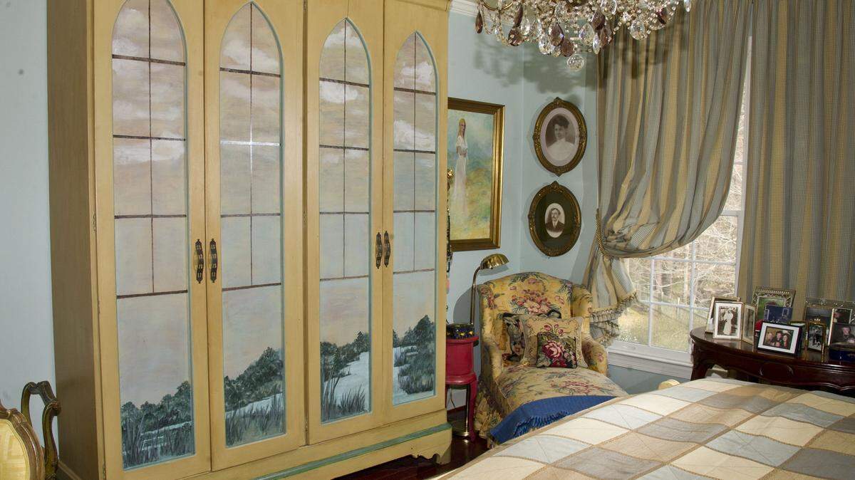 This armoire was built by Jim Hughes with salvaged mahogany. It was painted with a marsh scene by Audrey P. Raby.