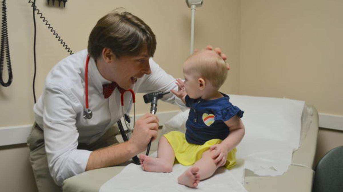 Dr. Daniel Gordon, a Mercer University graduate who is now a family physician in Hartwell, is pictured with a young patient.