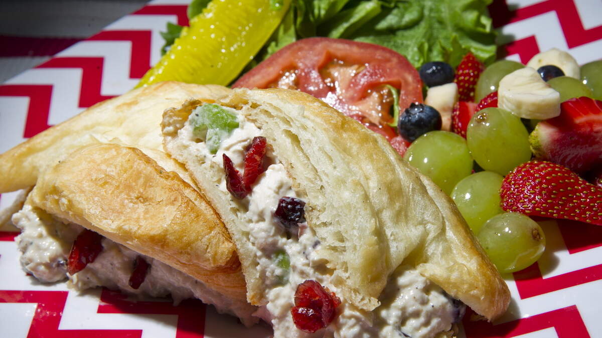Molly's Classic chicken salad on a croissant with a side of fruit from Red Rooster Cafe is one of the eatery's lunch combos.