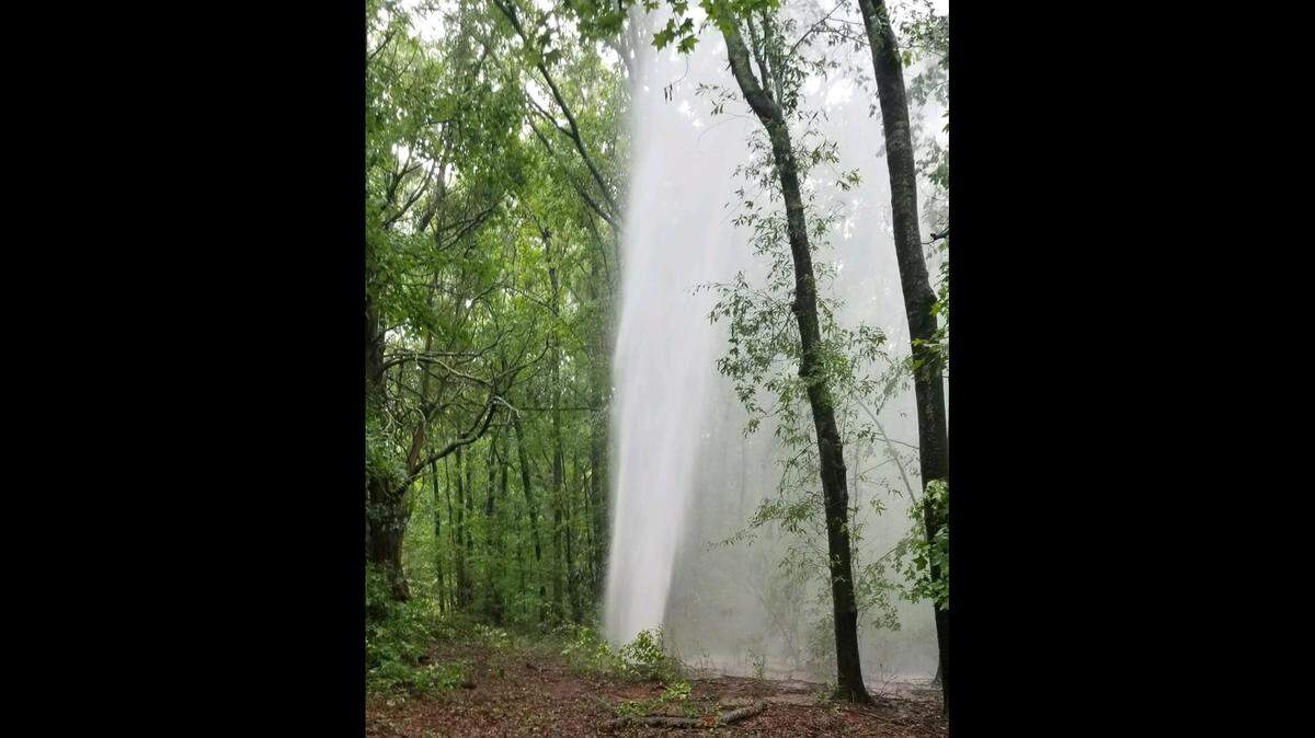 Water gushes up from a main break near the city of Forsyth water treatment plant on Sunday. The break has now been repaired but residents are urged to continue to conserve water.
