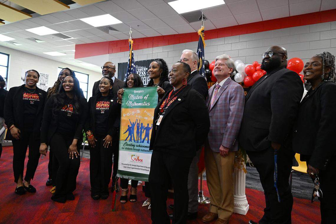 Appling Middle School staff pose with their math achievement banner alongside Bibb County School Board members and Georgia State School Superintendent Richard Woods on Monday, March 2, 2026, at Appling Middle School in Macon, Georgia. Superintendent Woods awarded nine Bibb schools banners representing growth and achievement in reading and mathematics during the 2024-2025 school year.