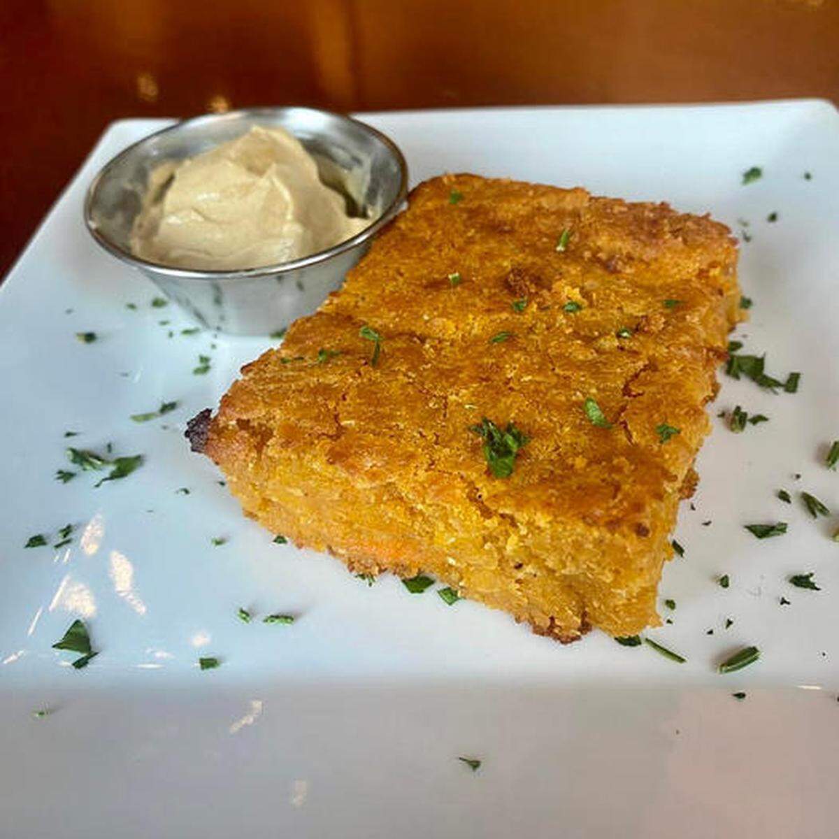 Sweet potato cornbread served with cinnamon brown sugar honey butter at The Cotton Ranch in Downtown Macon.