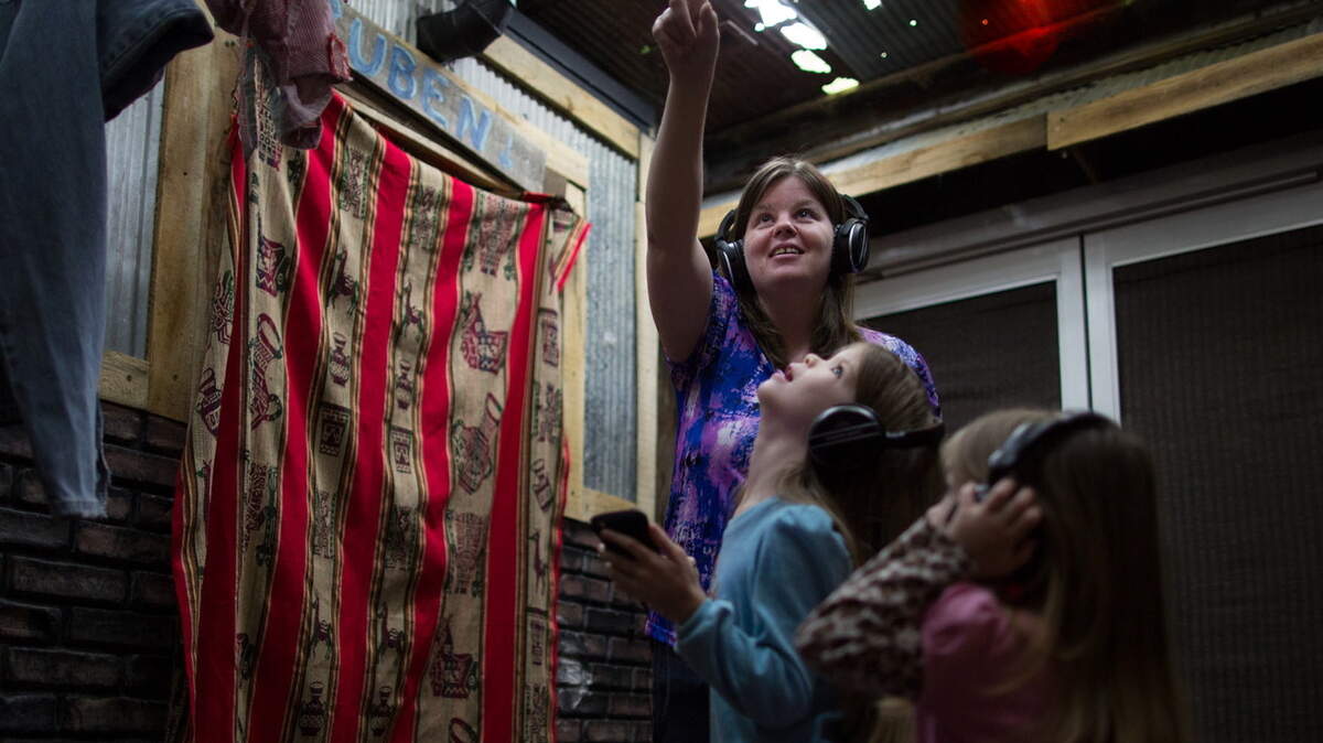 People check out the mobile Compassion Experience at one of its stops. It’s an interactive exhibit covering 2,000 square feet where visitors are taken into children’s daily lives, homes, markets and schools. It’s self-guided via recordings by children native to the setting.