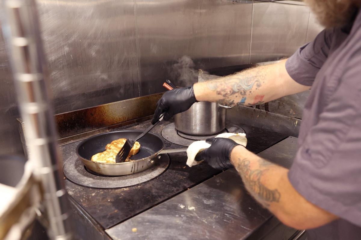 Hotel Forty Five executive chef Jayson Reynolds prepares French toast in the kitchen of Loom on Tuesday, Aug. 6, 2024, in downtown Macon, Georgia. Tuesday marked only the second day of breakfast service at Loom, a new addition since Reynolds’ hiring. Reynolds said that he is still working to perfect the menu and establish an identity for Loom under his leadership.
