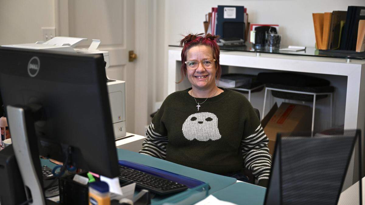 Angela Scott, an executive administrator for a house of people in recovery, works at her desk on Oct. 30, 2025, at Lighthouse Law Firm at 564 Mulberry St. in downtown Macon, Ga. Scott also works as a spiritual and recovery specialist while she goes through rehabilitation after being incarcerated.