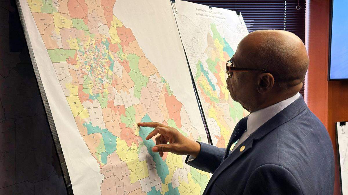 FILE - Georgia Rep. Mack Jackson, D-Sandersville, looks at a map of proposed state House districts before a House hearing, Nov. 29, 2023, at the state Capitol in Atlanta. On Tuesday, Dec. 12, plaintiffs who successfully sued to overturn Georgia’s legislative and congressional districts asked a federal judge to reject Georgia’s new Republican-backed maps. (AP Photo/Jeff Amy, File)
