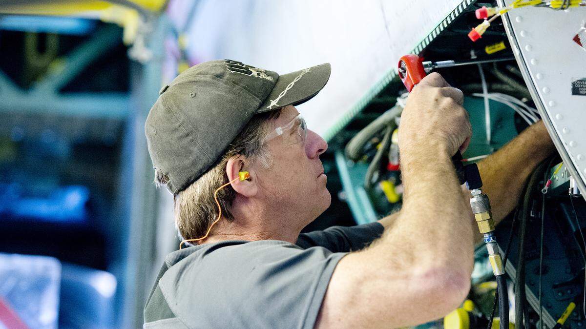 Electrician Ronnie Horn works on an F-15 at Robins Air Force Base on Tuesday afternoon. Electricians are almost finished completely with rewiring work on 122 F-15s, done over the past five years.