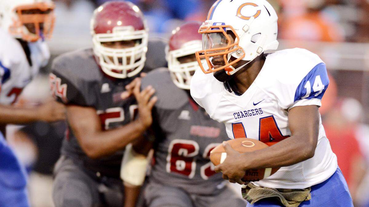 Central quarterback Derrick Evans (14) runs for a first down during their game Friday night against Howard.