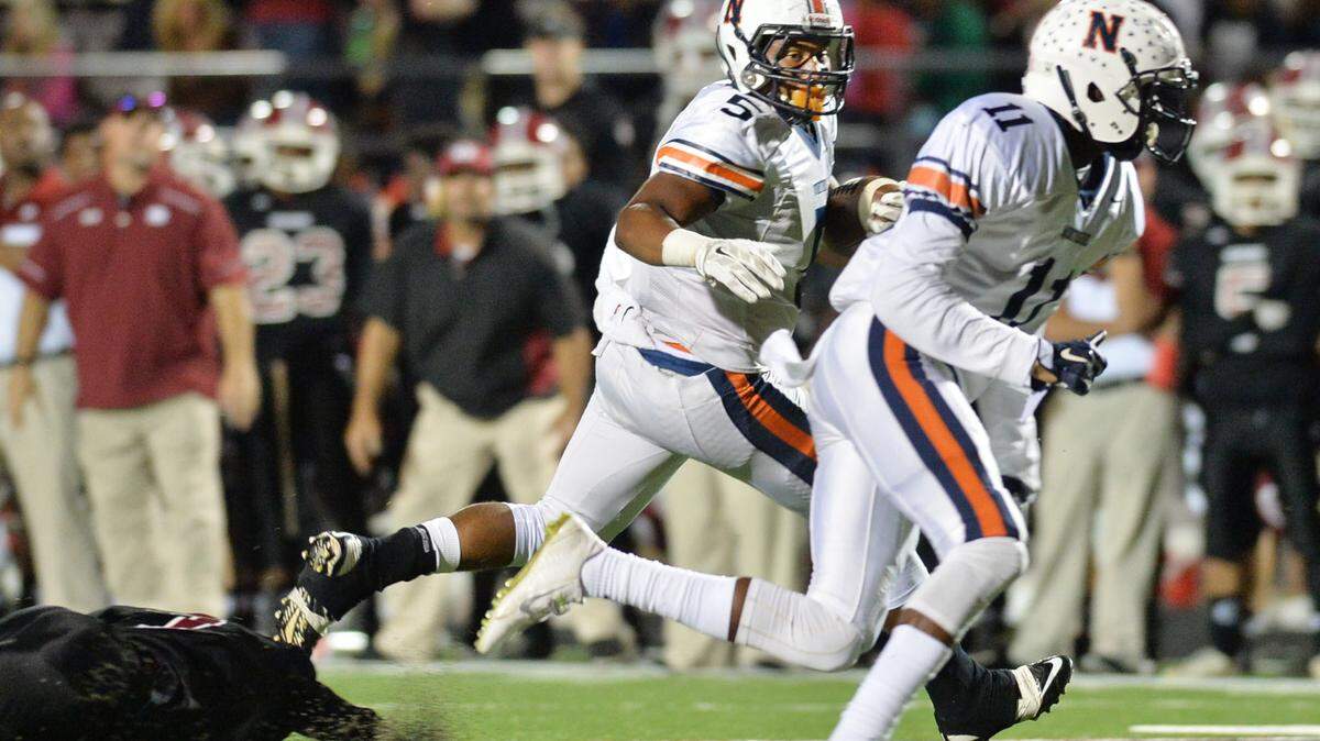 Northside running back Desean Dinkins (5) follows his blockers and leaves the Warner Robins defenders in the dust en route to the Eagles' first touchdown in their 58-14 victory.