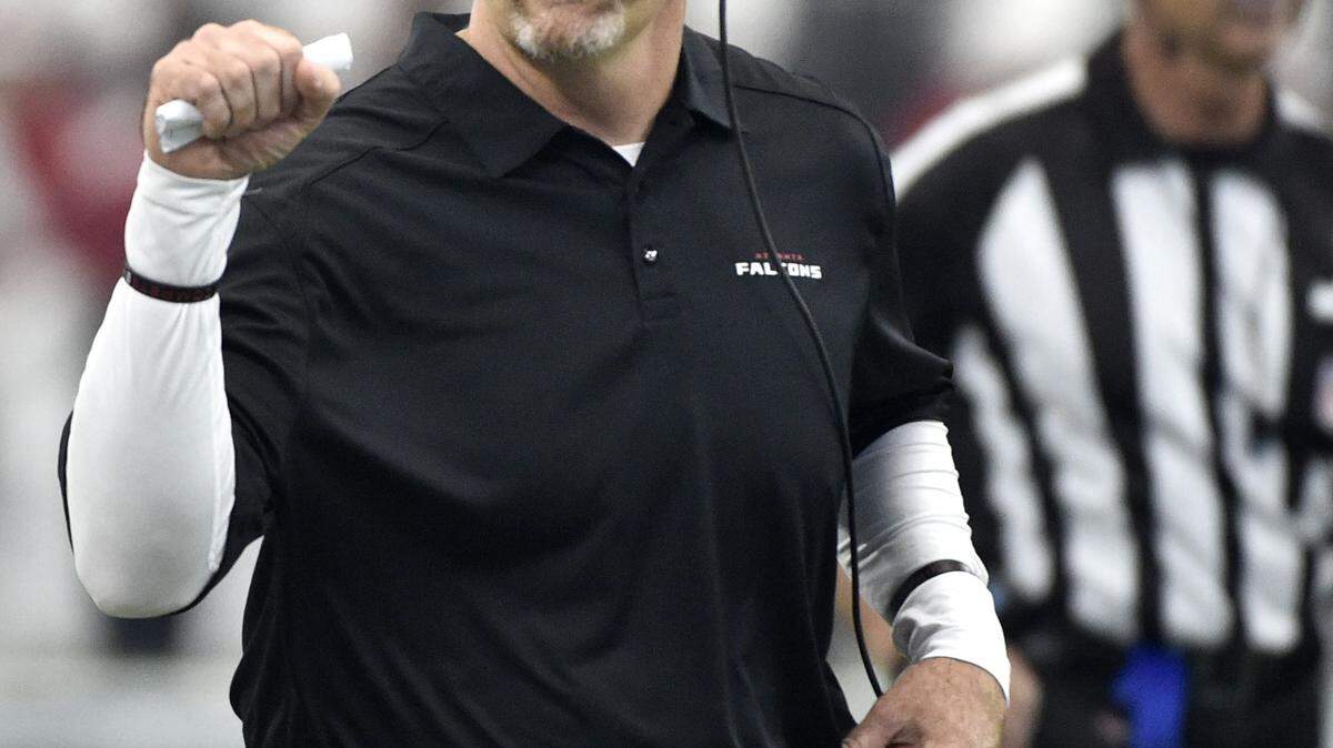 Atlanta Falcons head coach Dan Quinn walks along the sideline while signaling to his staff in the first half of an NFL football game against the Dallas Cowboys, Sunday, Sept. 27, 2015, in Arlington, Texas. (AP Photo/Michael Ainsworth )