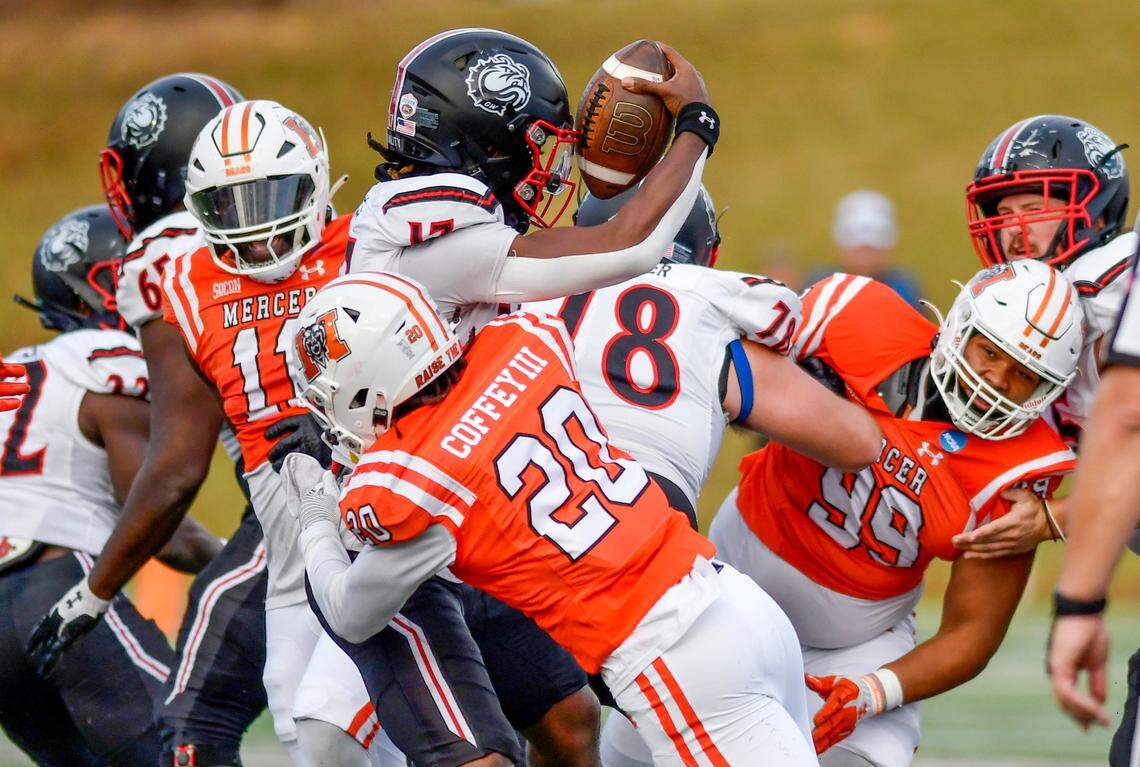 Mercer safety Richie Coffey (20) sacks Gardner-Webb quarterback Jaylen King (17) during their FCS playoff game Saturday in Macon.