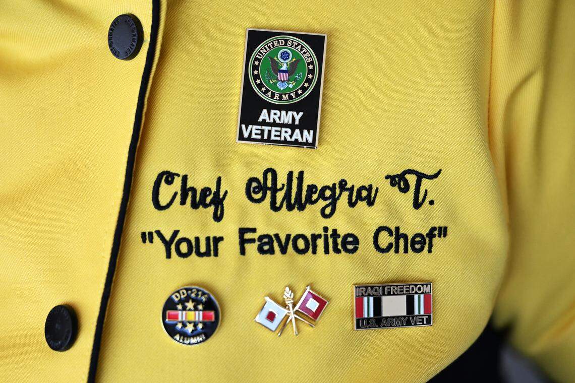 ABC Catering, LLC owner Allegra Lowe displays pins honoring her service in the U.S. Army on her chef’s coat.