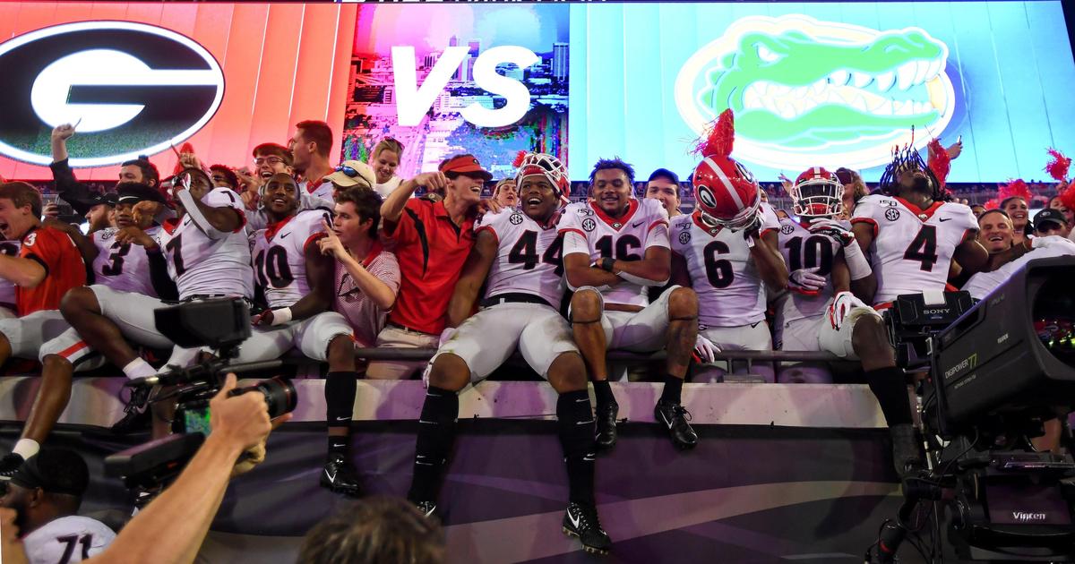 Georgia Bulldogs fans and players celebrate after the Bulldogs’ 24-17 win over the Florida Gators in Jacksonville, Fla.