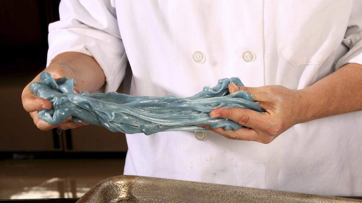 Grease your hands with butter before pulling the taffy.