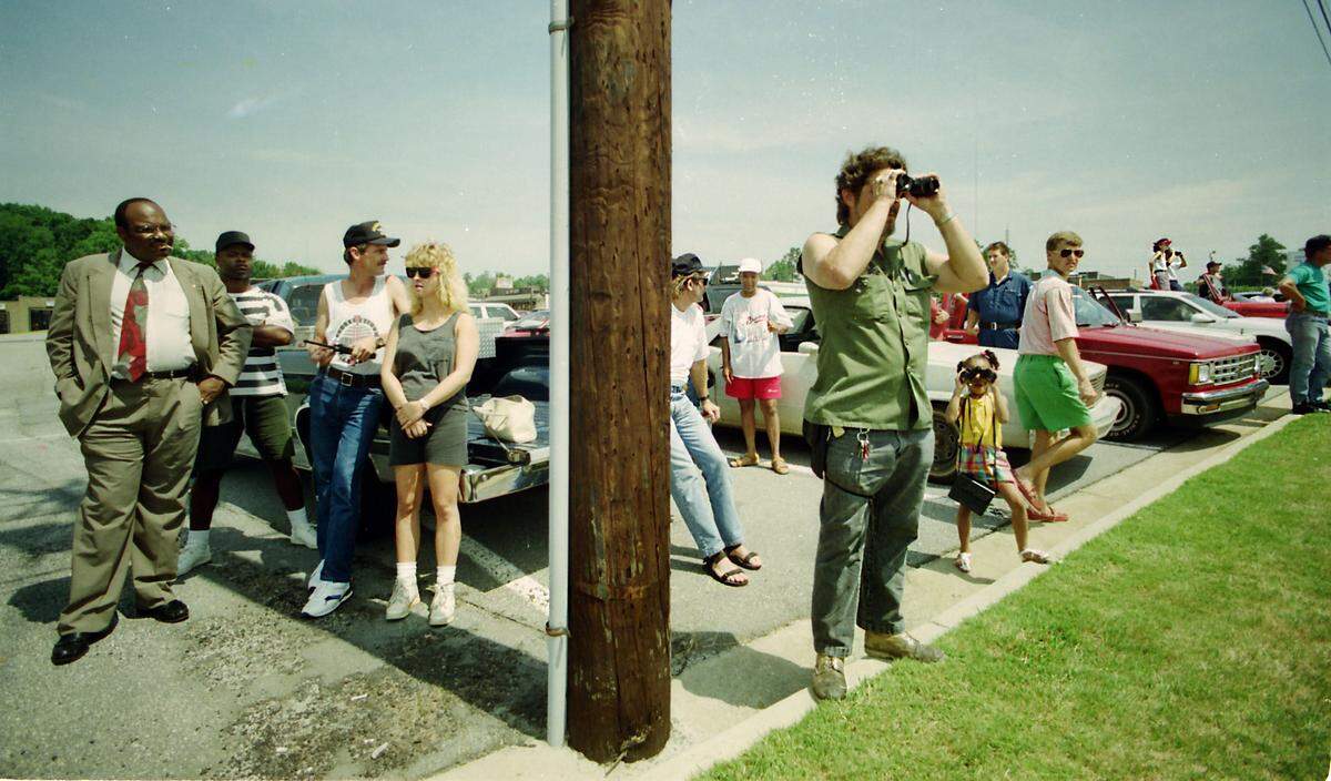 Onlookers in a parking lot near an Olive Garden across from the Macon Mall tried to get a glimpse of hostage-taker Lafayette Hall and police negotiators during a standoff.