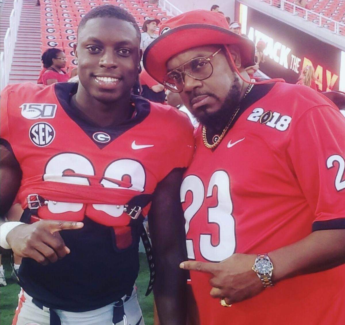 Mark Webb, Jr. (left), and his father Mark Webb, Sr., pose for a photo together.