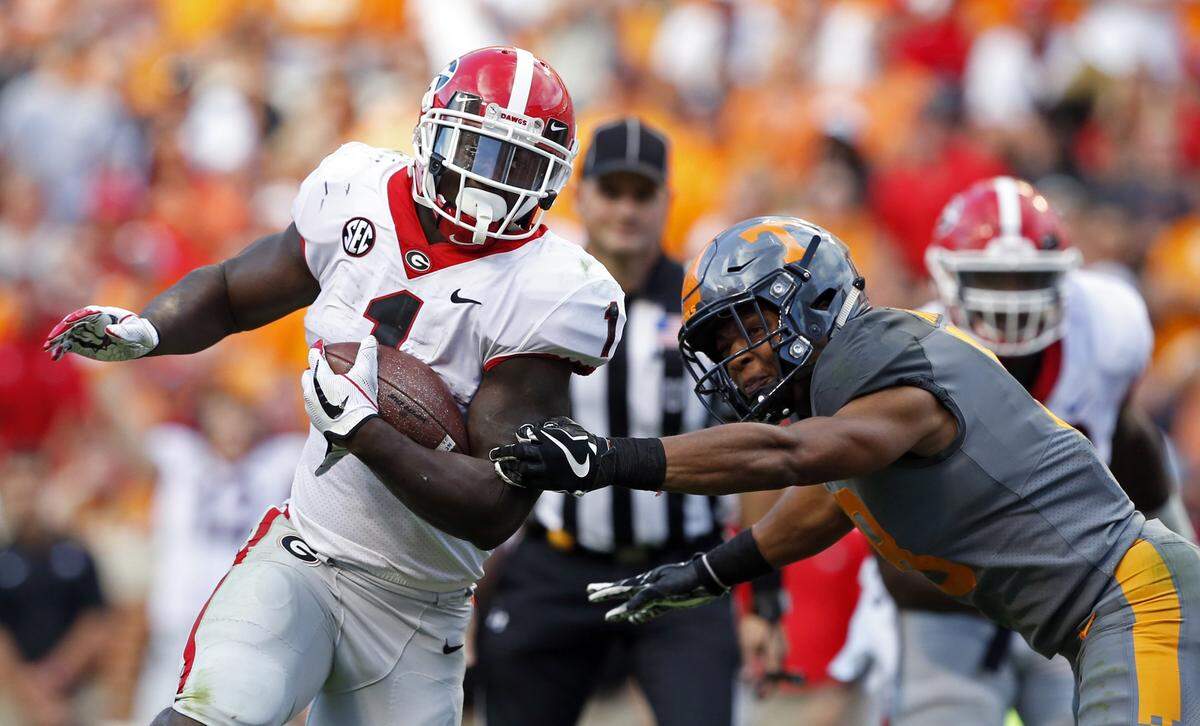 Georgia running back Sony Michel (1) outruns Tennessee defensive back Justin Martin (8) in the second half of an NCAA college football game Saturday, Sept. 30, 2017, in Knoxville, Tenn. Georgia won 41-0.