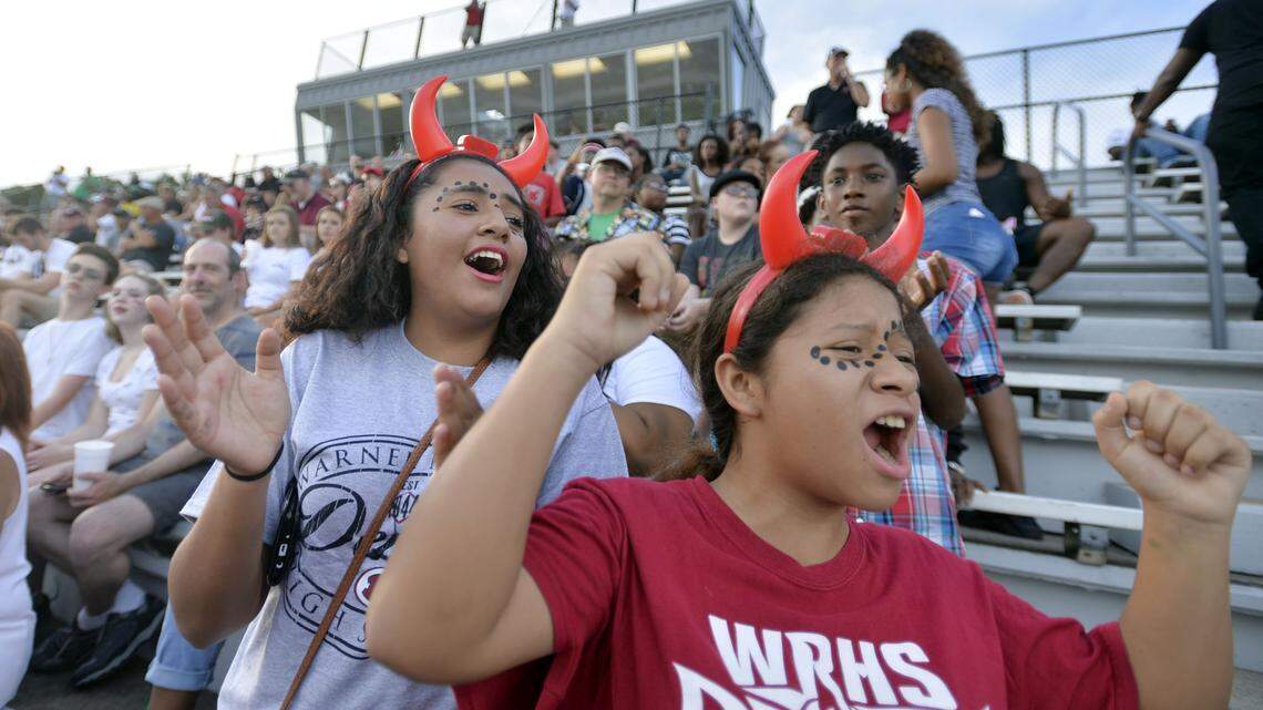 Warner Robins fans Abby Guevara, left, and Wendy Castillo, wearing their best Demon hats, cheer their favorite team in this 2016 Telegraph file photo.