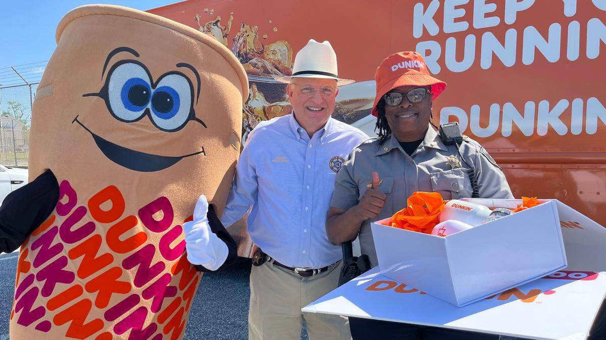 Bibb County Sheriff David Davis (left) and Sgt. Angela Endsley posed with Cuppy, the Dunkin’ Donuts mascot in front of the franchise’s food truck which surprised them at the sheriff’s office in April 2025.