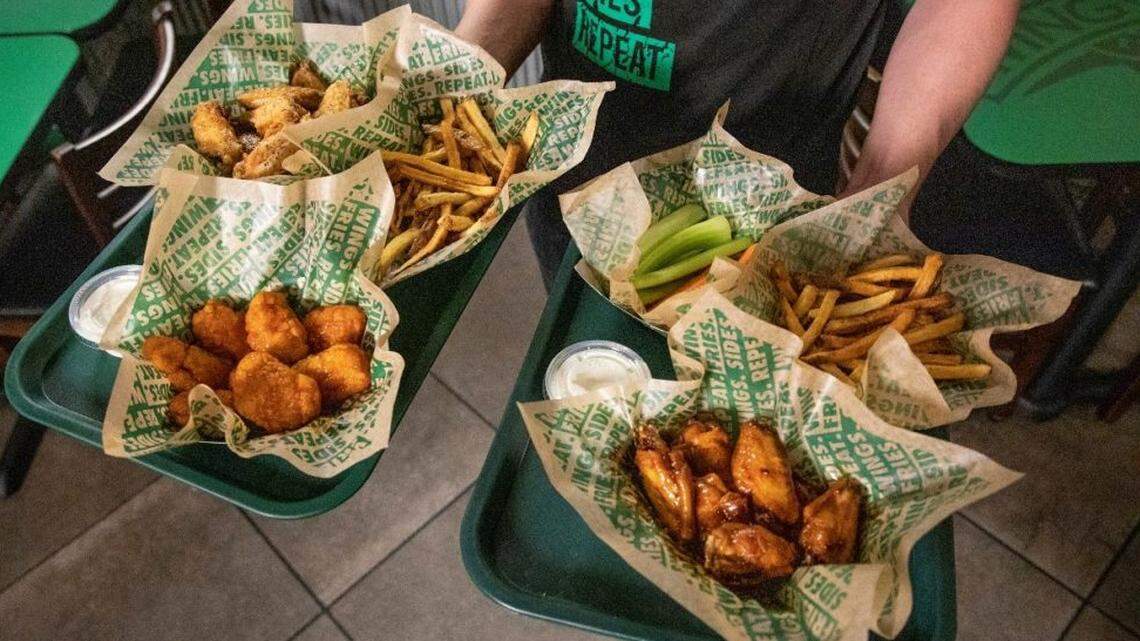 Trays of food, including wings, from a Wingstop restaurant.