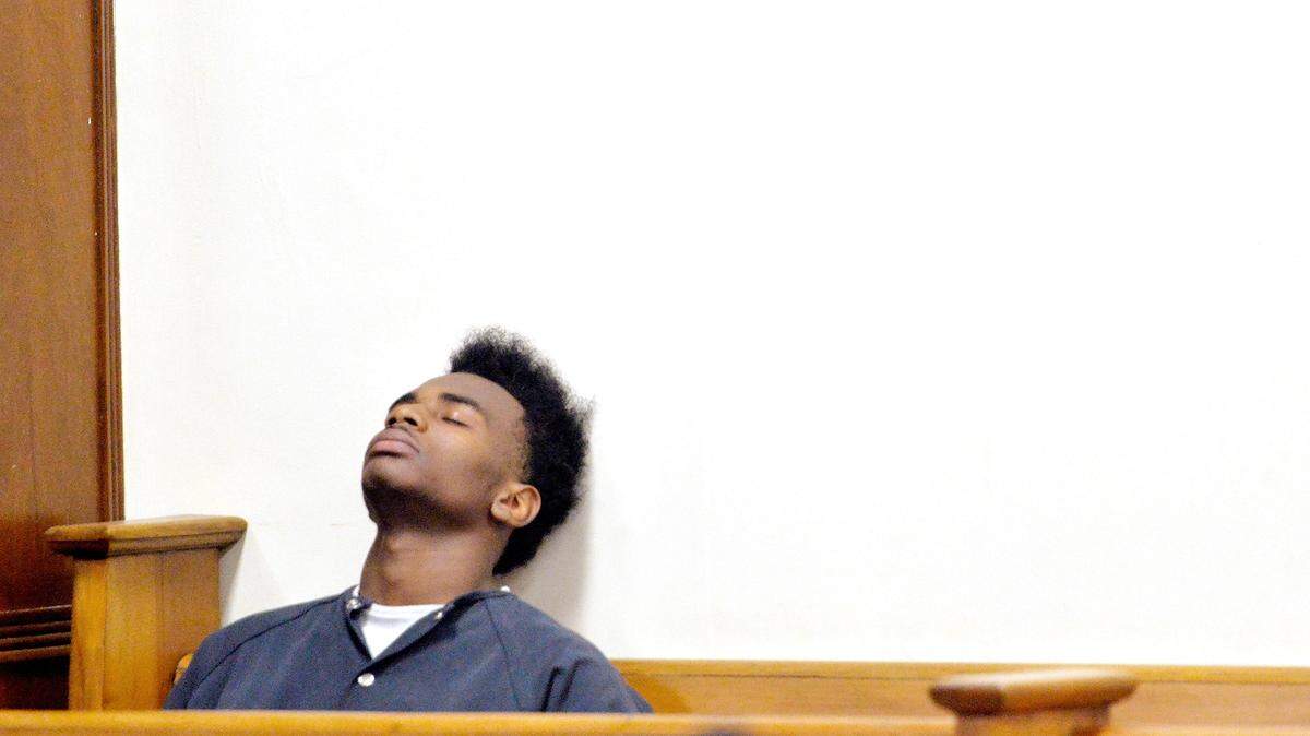 JASON VORHEES/THE TELEGRAPH Macon, GA, 01/12/2015: 
 16-year-old Demarcus Smith leans against the wall in a Bibb County courtroom while waiting for his first appearance hearing. Smith is charged with the murder of Kemani Ridgeway.