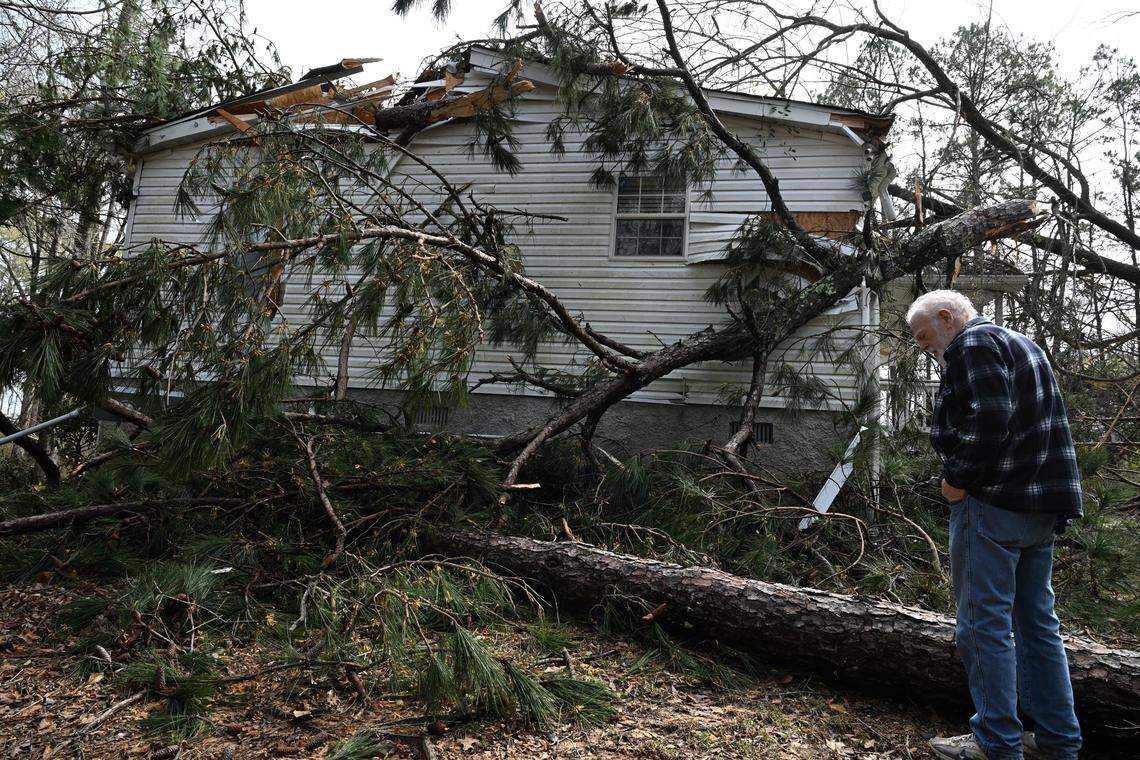 Mahlon Mclean stands outside his house where trees fell and damaged his roof on Thursday, March 12, 2026, off of Thomaston Road in Macon, Georgia. McLean said he and his wife were not injured and none of their items inside the house were damaged.