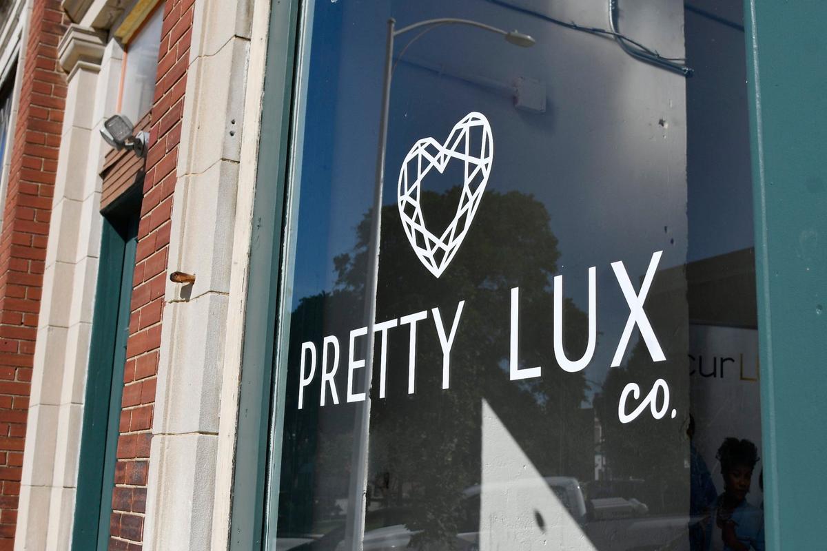 A decal advertising Pretty Lux Co. sits outside of Pretty Lux Co. off of 3rd Street on Friday, May 31, 2024, in downtown Macon, Georgia. Pretty Luxe Co. offers candle making workshops and also sells organic home goods and skin care products.