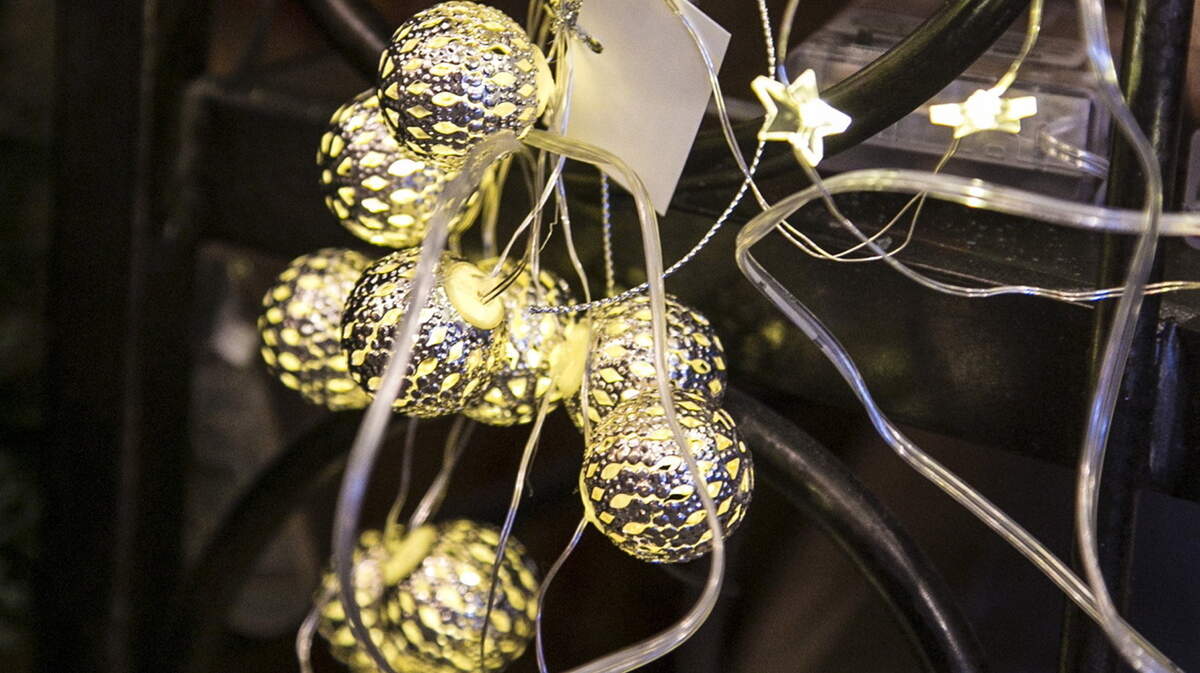 Strings of battery-operated lights feature a variety of covers, including candles and pine cones or simple teardrop lights.