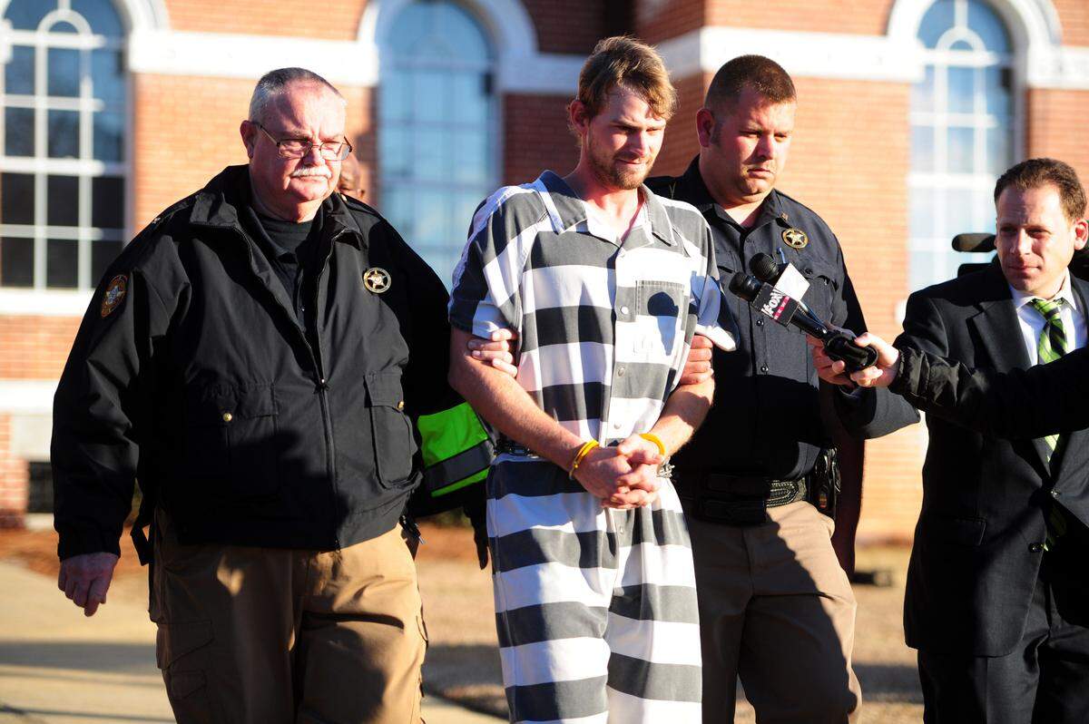 Ronnie Adrian “Jay” Towns pictured here being led from a south Georgia courthouse in January 2015 after being charged with murder and armed robbery in the deaths of Bud and June Runion.