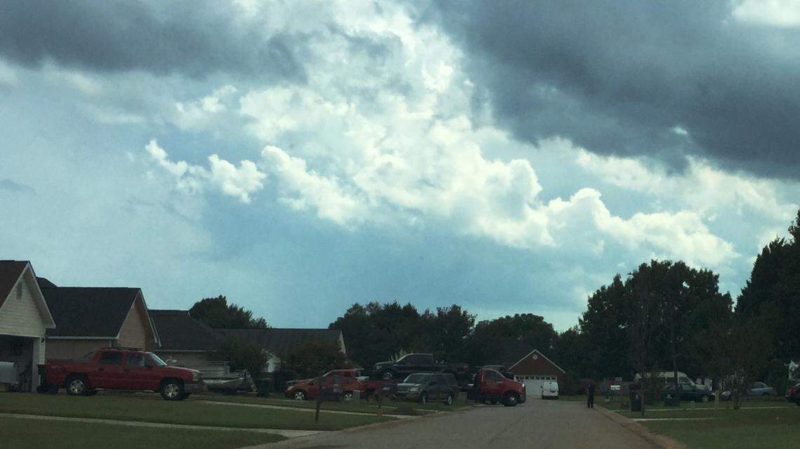 A Warner Robins police officer supervises the hauling away of two pickup trucks from a Franklin Square home where a man was shot dead in the head Sept. 29 in this Telegraph file photo.