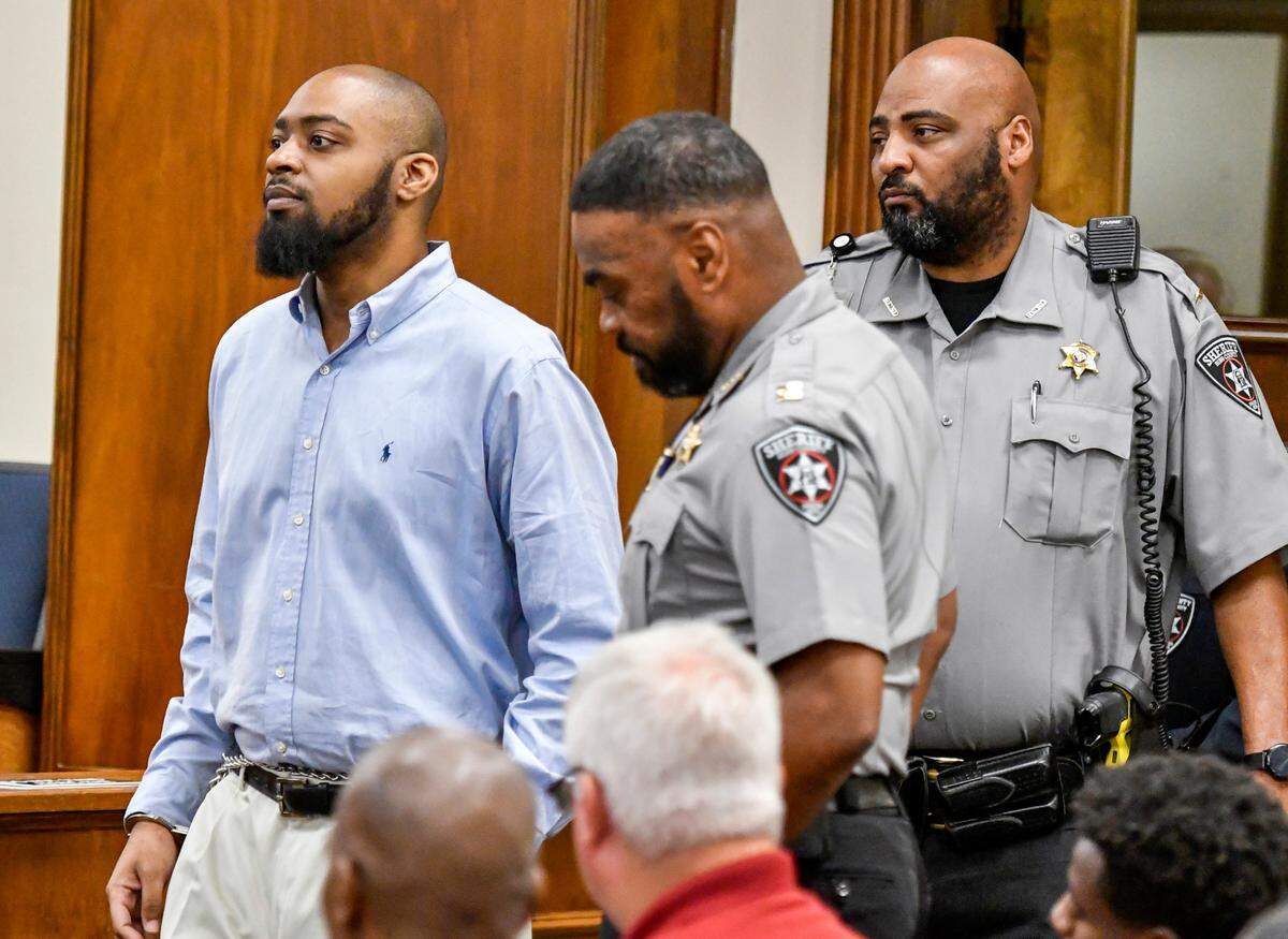 Caesar Zamien Crockett walks in a Bibb County Superior courtroom during his murder trial Tuesday afternoon. Crockett is accused of shooting the grandparents and aunt of his child in 2020.
