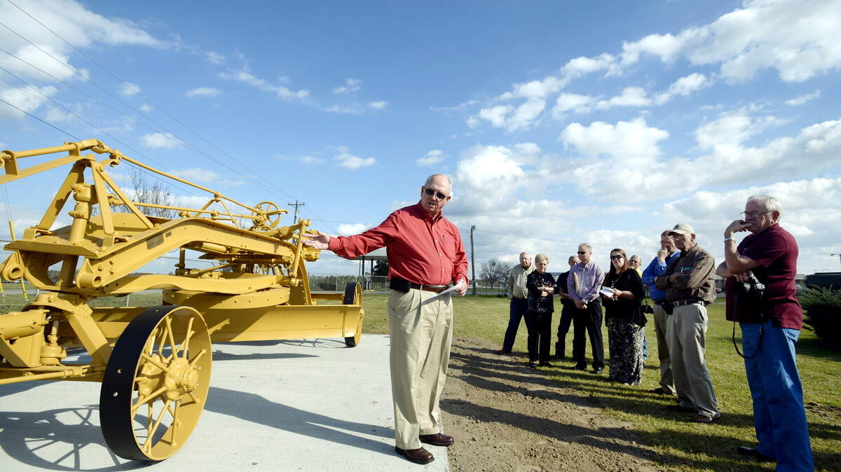 Houston County Commission Chairman Tommy Stalnaker speaks during a dedication ceremony for a restored Caterpillar Model 35 road grader outside the County Public Works building in Perry Thursday.