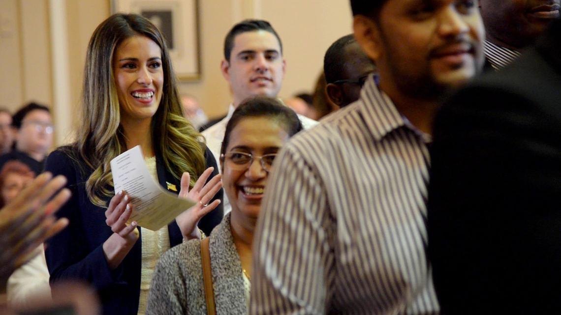 JENNA EASON/THE TELEGRAPH Macon, GA, 04/17/2019: Estafania Ramirez, left, claps and cries after finishing the Oath of Allegiance at her naturalization ceremony in the William Augustus Bootle Federal Building and U.S. Courthouse on Wednesday, April 17, 2019.