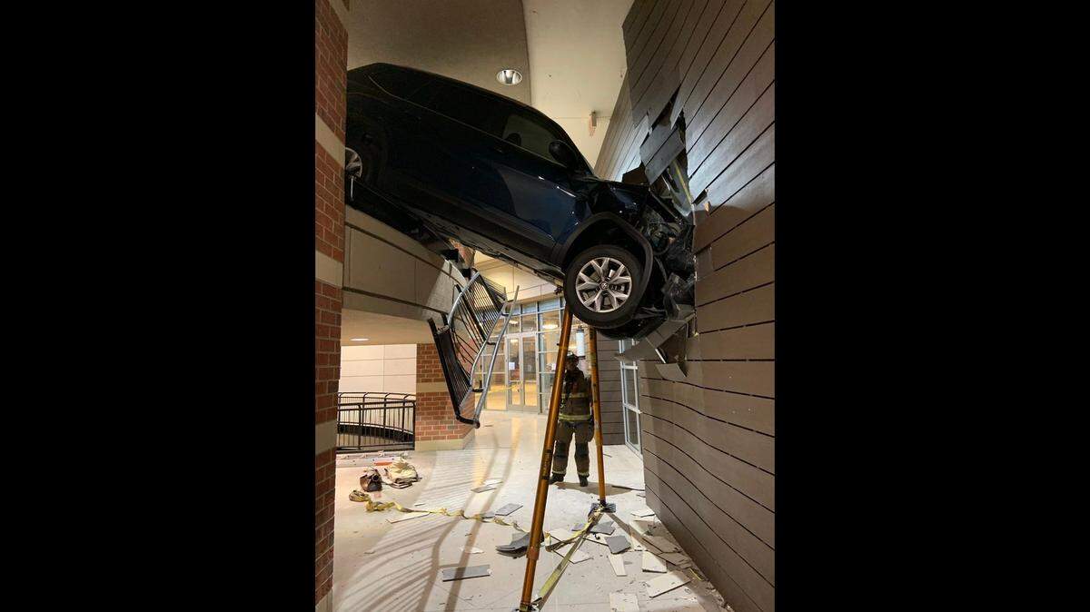 A woman was rescued after an SUV went off a parking deck, Georgia firefighters say.