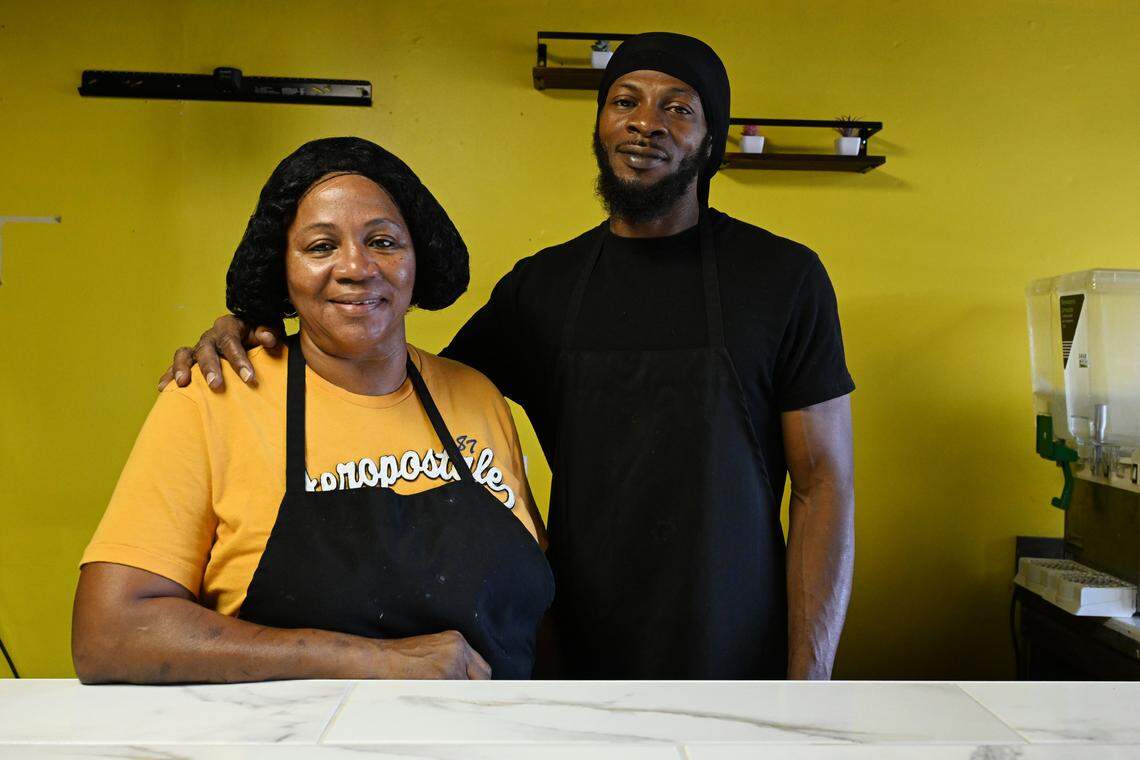 Comfort Foods Kitchen & Grill owner Adrena James (left) and her son Terrence Bey pose at the counter of their restaurant on Monday, Aug. 25, 2025, in Warner Robins, Georgia. Comfort Foods Kitchen & Grill serves Southern comfort food for breakfast and lunch.