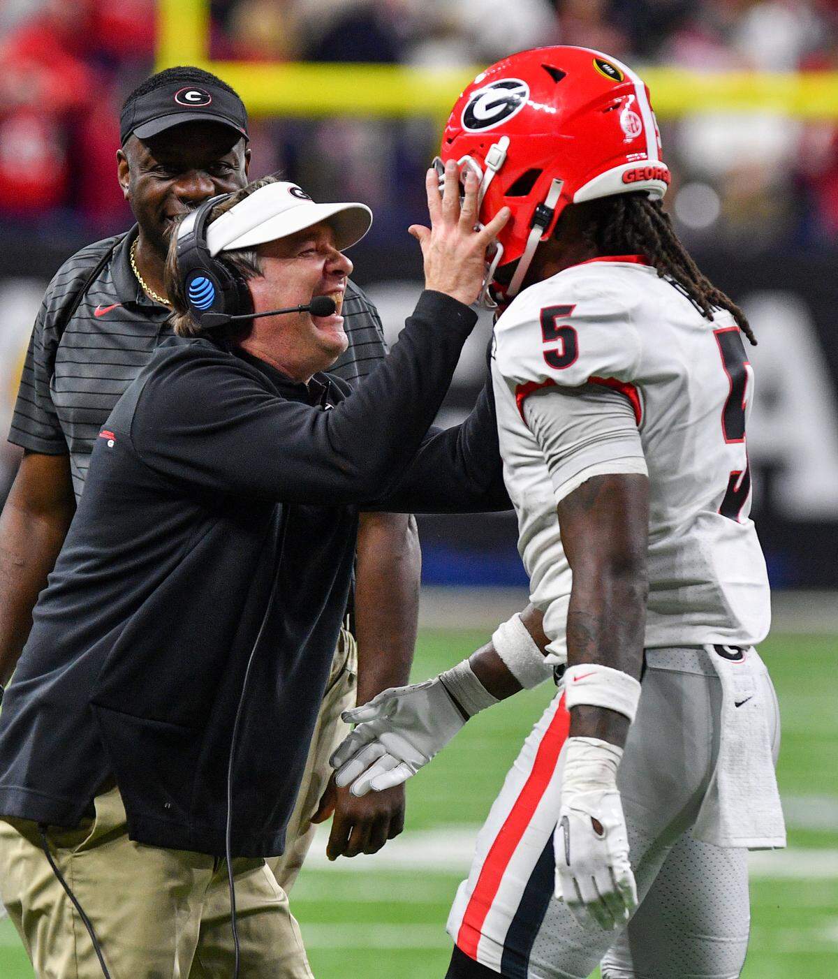 Georgia head coach Kirby Smart celebrates with Kelee Ringo (5) after Ringo’s interception returned for a touchdown in the Bulldogs’ 33-18 win over Alabama in the College Football Playoff National Championship game Monday night.