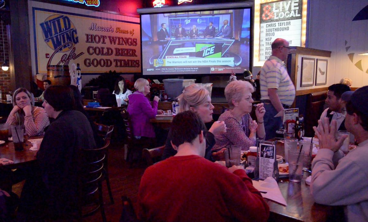 Customers of Wild Wing Cafe participate in their weekly trivia night on Wednesday.