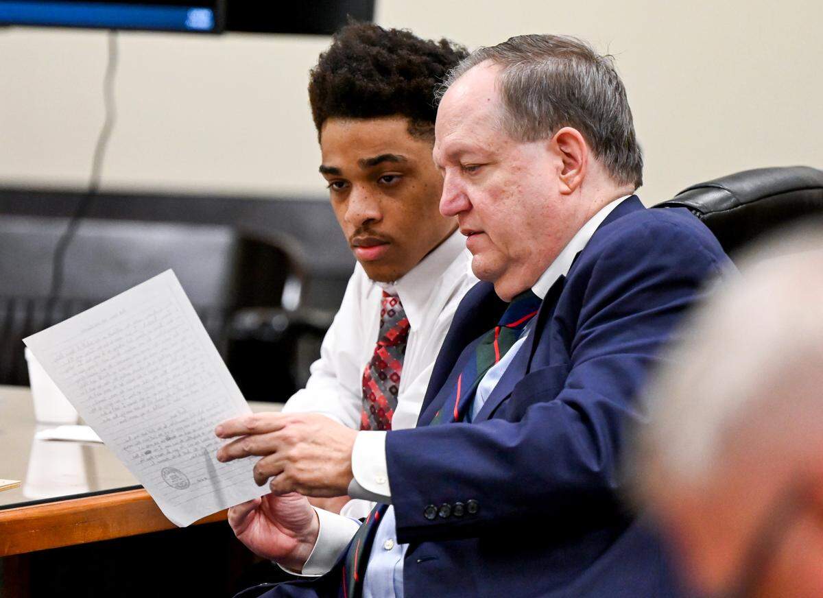 Jeremy Kendrick Jr. speaks with his attorney Floyd Buford during his murder trial in a Bibb County Superior courtroom Thursday afternoon. Kendrick Jr. is charged in the holdups and killings of the clerks, who were slain a week apart in August 2018.