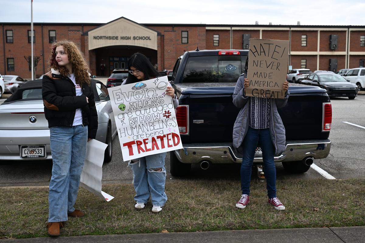 Students wait outside Northside High School before the start of a school day protest against U.S. Immigration and Customs Enforcement (ICE) on Friday, Jan. 23, 2026, in Warner Robins, Georgia. The march occurred during school hours.
