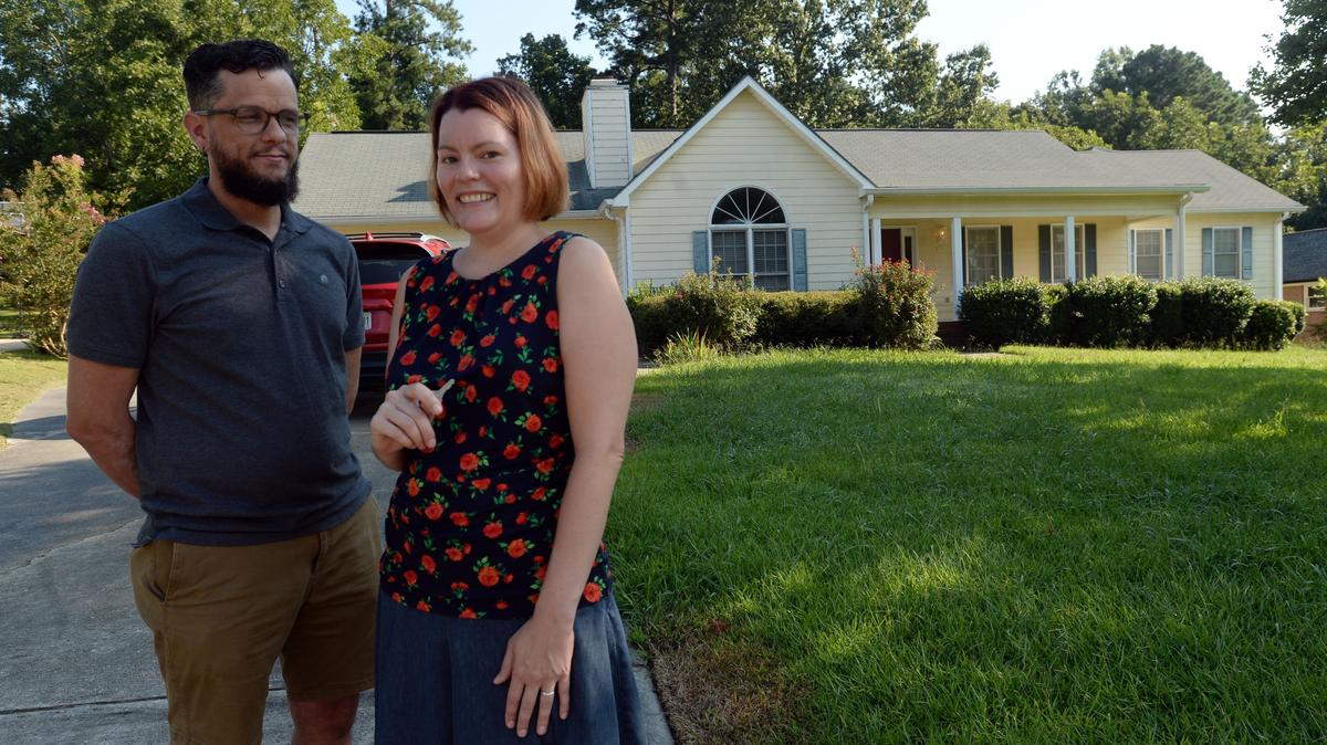 Duane and Brooke Day stand outside the home they recently contracted to buy in north Macon where they said the market was so hot, new homes coming onto the market were viewed by multiple families on the first day.