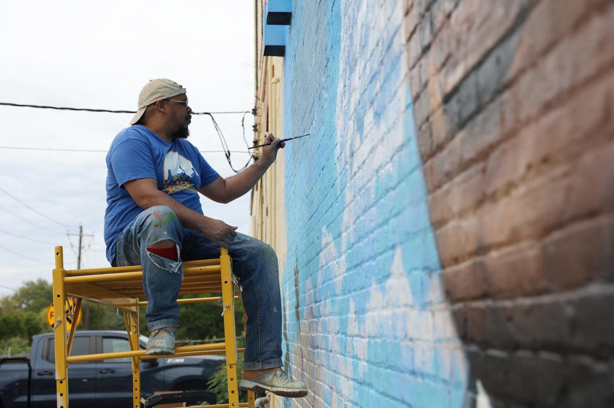 Kevin “Scene” Lewis works on a mural of Rev. Martin Luther King Jr. on Wednesday, Sept. 11, 2024, off of Martin Luther King Jr. Boulevard in Macon, Georgia. The mural will depict King as well as cherry blossoms and Zion Baptist Church, the last place King visited in Macon before his assassination in 1968.