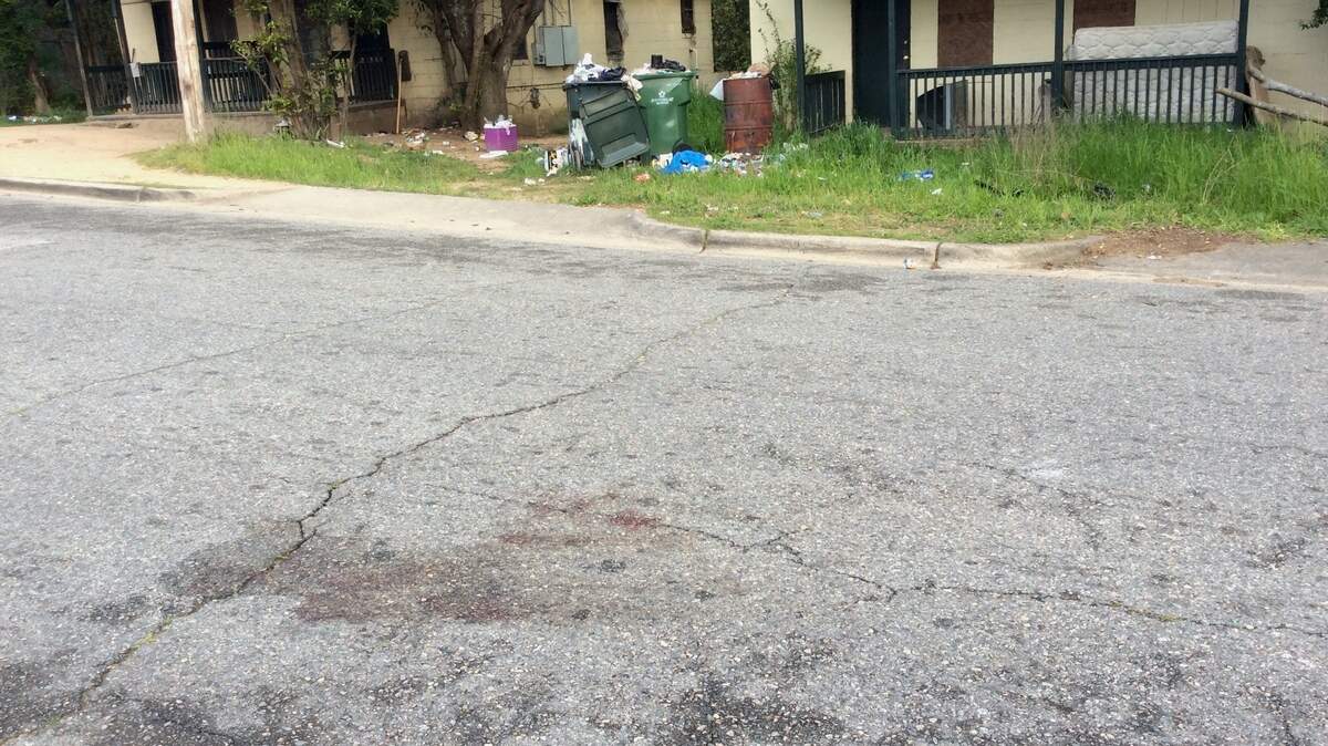 Blood stains mark the spot on Elpis Street where Bibb sheriff's deputies found Jamarta Chennelle Clark suffering from multiple gunshot wounds early Thursday.