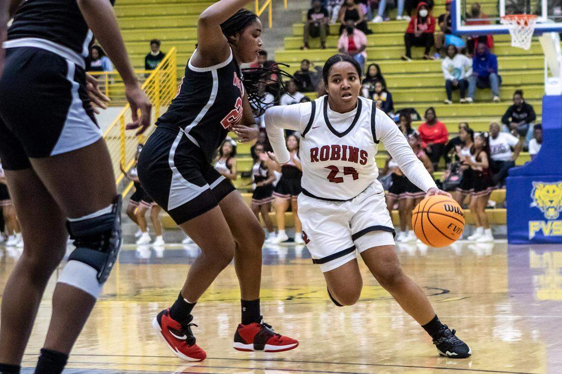 Warner Robins’s Tori Davis (24) drives to the lane against Woodward Academy in the 5A Quarterfinal game.