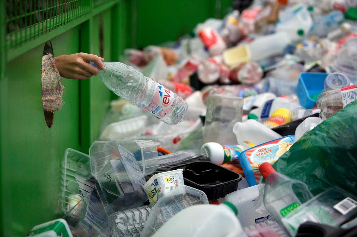 A woman depositing a plastic bottle in a recycling bin in Worcestershire, UK. Brightmark, a global waste provider, plans to build a $680 million facility in Macon, Georgia, which recycles all plastics into reusable goods like fuel and wax.