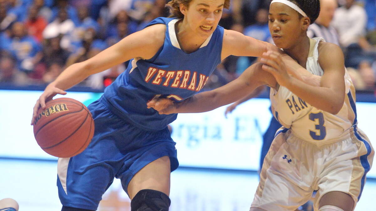 Veterans' Audrey Nicholson (15) drives past Americus-Sumter's Jykiera Long (3) during Thursday's GHSA Class AAAA girls basketball championship game at the Macon Coliseum.
