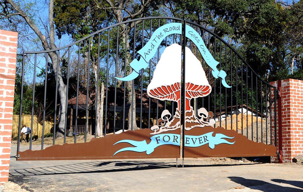FILE PHOTO/THE TELEGRAPH Macon, Georgia, 11/27/09: A mushroom and The Road Goes on Forever adorn the gates of The Big House Museum. The house was once the headquarters for the Allman Brothers Band. Curator E. J. Devokaitis, Kirk West and project manager Greg Potter outside the house Friday morning.